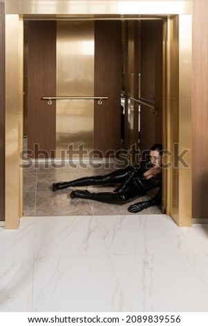 Hit woman. Woman in a latex suit killed in gunfire shot in the chest

 Royalty-Free Stock Photo #2089839556