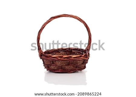 Wicker basket made of willow branches. Isolated over white background. Close-up.