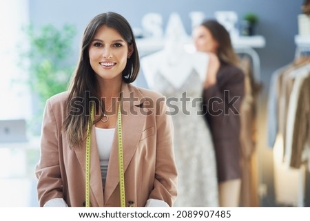 Young nice tailor woman with measure tape