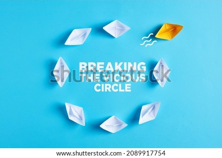 One paper boat breaks the vicious circle. Breaking the vicious circle or ending the routine concept. Royalty-Free Stock Photo #2089917754