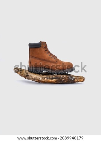 Photo of brown winter boots on a white background. Outdoor poster