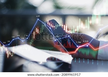 Close up of businessman hand using smartphone with glowing forex chart trading interface on blurry outdoor background with sunlight. Market, economy and data exchange concept. Double exposure