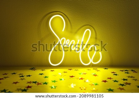 Yellow neon sign smile with confetti. Trendy style. Neon sign. Custom neon. Home decor.