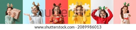 Funny little girl with reindeer horns on color background