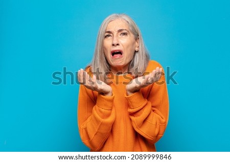 middle age woman looking desperate and frustrated, stressed, unhappy and annoyed, shouting and screaming