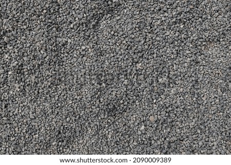 Gray gravel background, top view texture of small rocks