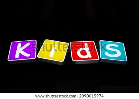 illuminate cubes with text Kids on black background 