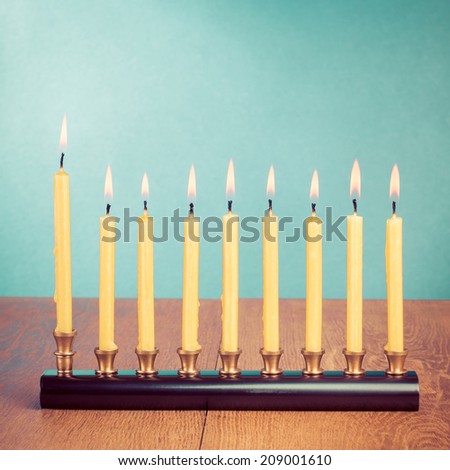 Hanukkah menorah with burning candles on table