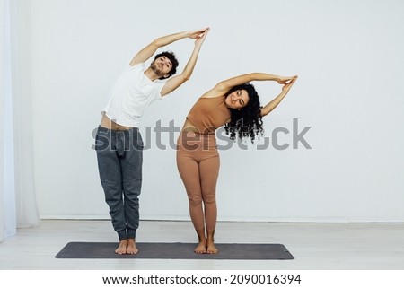 Man and woman doing exercises yoga asana fitness gymnastics