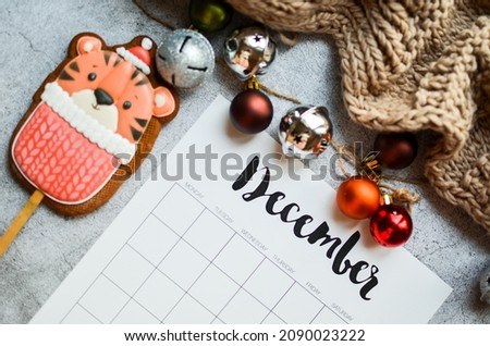 2021year end review, date planning, appointment, deadline, or holiday concept on the wooden table next to the black clean calendar on the month of December 2021.