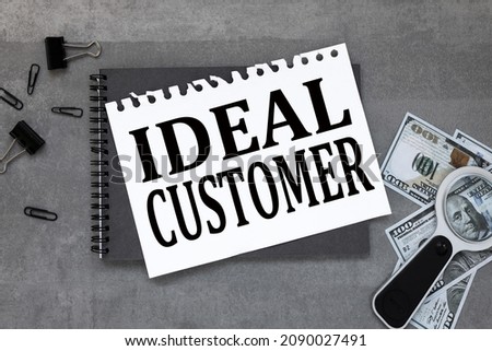 Ideal Customer. On the desktop, a gray notepad, reports, a white sheet of paper