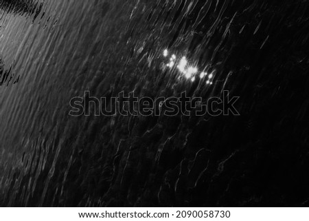 black and white texture of water, blurring and blurring of the image, soft focus and defocusing of the water element, glare and reflections