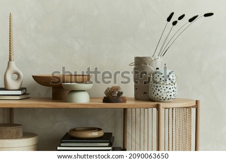 Stylish composition of personal accessories on the console in the living room. Sculpture, candlectick, minerals and tray. Copy space. Template.