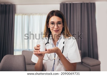 Woman wearing white coat stethoscope on shoulders looking at camera, counseling and therapy concept