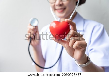Cropped shot of healthcare worker holding a red heart toy with Stethoscope. Stethoscope is a device for listening to internal sounds of an animal or human body for medical examination.