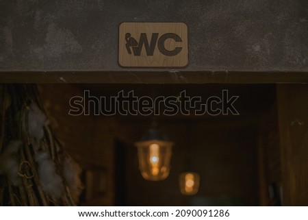 Toilet sign in the bar. Wooden WC sign in coffee shop. High quality photo