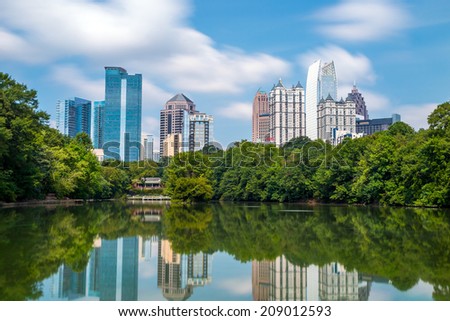 Skyline and reflections of midtown Atlanta, Georgia in Lake Meer from Piedmont Park.