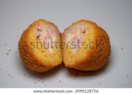 large and tasty open fried balls, made with rice, ham and mozzarella cheese called ARANCINI DI RISO in Italian language.  Royalty-Free Stock Photo #2090128756