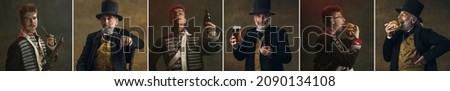 Young and old men in image of medieval royalty persons in vintage clothing with drinks and snacks on dark background. Concept of comparison of eras, modernity and renaissance, baroque style. Royalty-Free Stock Photo #2090134108
