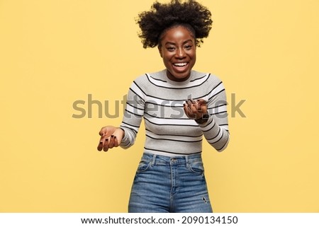 Laughing. Half-length portrait of young woman in warm casual style clothes isolated on yellow background. Concept of emotions. Concept of emotions, facial expression, youth, ad.