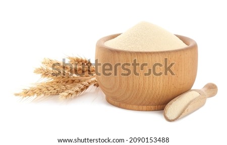 Semolina in wooden bowl and scoop on white background Royalty-Free Stock Photo #2090153488