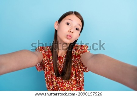 Photo of youth lovely lady pouted lips send air kiss make selfie blogging isolated over blue color background