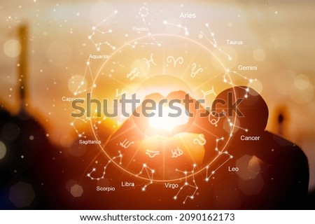 The hands are the heart shape with the sun light passing through the hands have astrological symbols Royalty-Free Stock Photo #2090162173
