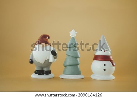 Close up Christmas figurine against yellow background