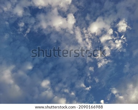 background and textured many clouds shaped like waves in the sea on blue sky.A lump that has a grayish white color


