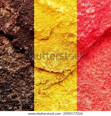 Grunge pattern of Belgium national flag weathered stone wall. Abstract Belgian politics history culture concept background