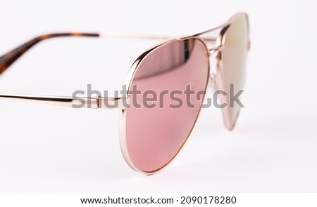Aviator sunglasses gold frame with multicolor green mirror lens isolated on white background with clipping path. glasses Royalty-Free Stock Photo #2090178280