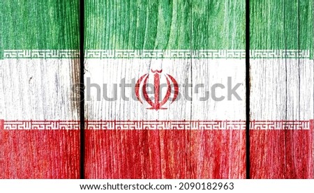 Grunge pattern of Iran national flag isolated on weathered wooden fence board. Abstract Iranian politics history culture concept background