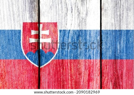 Grunge pattern of Slovakia national flag isolated on weathered wooden fence board. Abstract Slovakia politics history culture concept background