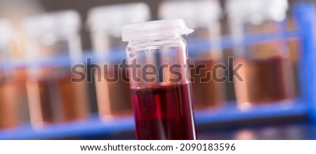 vial of liquid on a dark background