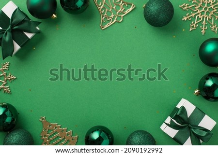 Top view photo of christmas decorations green balls gold bell pine snowflake shaped ornaments white gift boxes and shiny glitter on isolated bright green  background with blank space in the middle