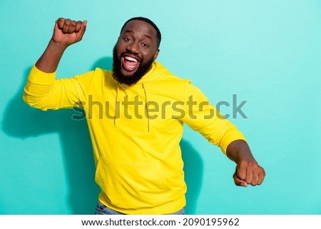 Photo of excited positive guy dancing floor favorite music single hit isolated over cyan color background