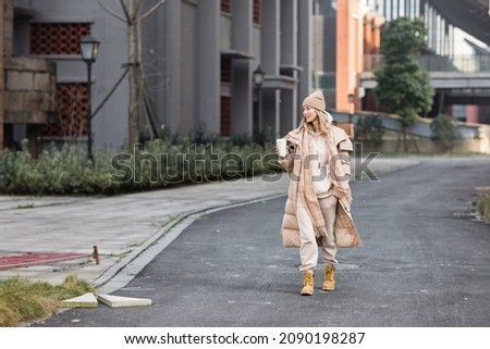 Woman drinking coffee outdoor. Color of the year 2021: ultimate gray. Trendy colors concept, mockup with copy space Royalty-Free Stock Photo #2090198287