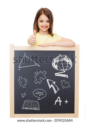 people, childhood, gesture, doodles and education concept - smiling little girl with blackboard showing thumbs up