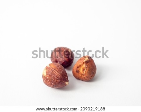 Hazelnuts on a white background.