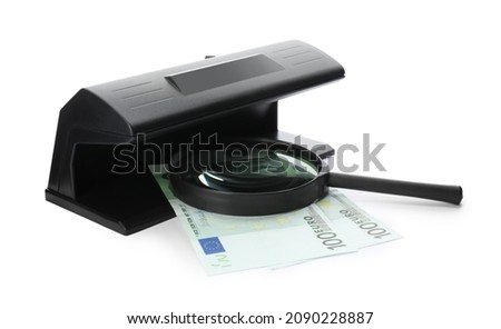 Modern currency detector with Euro banknotes and magnifying glass on white background. Money examination device