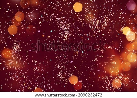 Colorful luxury red festive background of firework. Excellent Holiday texture for design greeting card, flyer for Christmas, New year, anniversary. Happiness and joy concept. Beautiful wallpaper