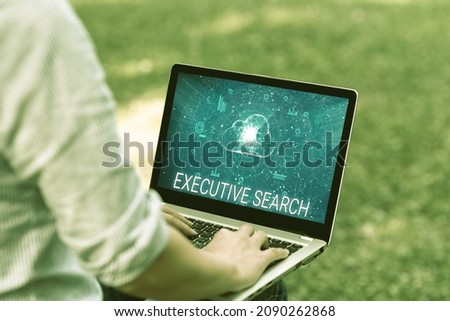 Sign displaying Executive Search. Business approach recruitment service organizations pay to seek candidates Woman Typing On Laptop Sitting Outside Back View Working From Home.