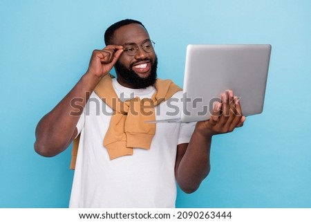 Photo of smiling good mood businessman in glasses working in laptop professional isolated on blue color background