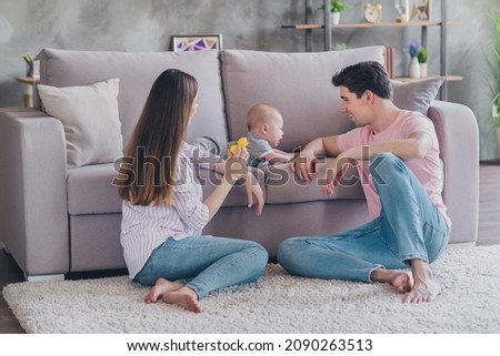 Photo of lovers couple mommy hold duck toy kid cry sofa wear casual outfit in comfortable apartment home indoors Royalty-Free Stock Photo #2090263513