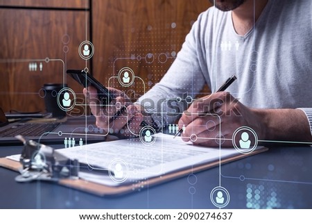 A potential employee signing the contract to boost his career and gain new opportunities in personal growth. Concept of success. Checking the detail of the deal at smartphone. Social media icons