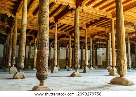 Hall with wooden columns in Juma Mosque, Khiva, Uzbekistan. Columns are unique in that they all different and don't have same design. Many columns brought from older and no longer existing mosques Royalty-Free Stock Photo #2090279758
