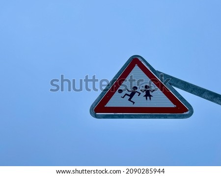 Street sign Kids playing, isolated against blue sky.