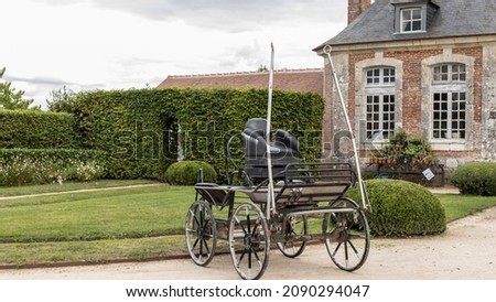 Old fashioned horse carriage stood in the court yard of a chateau