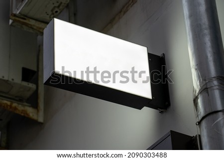 Blank gray round store signboard Mockup. Empty circular illuminated shop lightbox template mounted on wall. Mock up of illuminated blank signboard. Place for text, outdoor advertising, banner