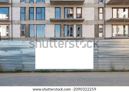 Blank white advertising banner on the fence of conctruction site